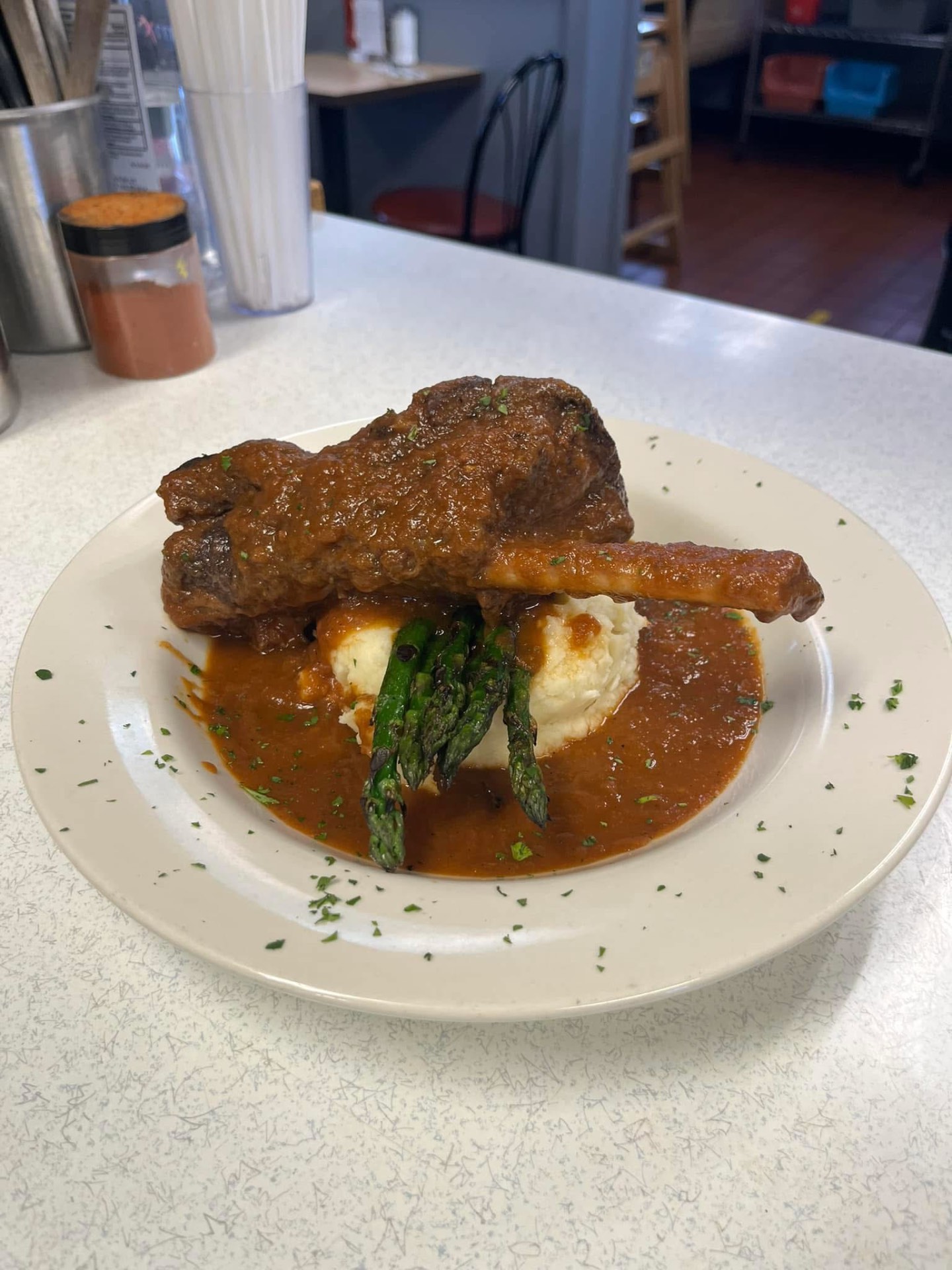 Braised short rib special over mashed potatoes with asparagus